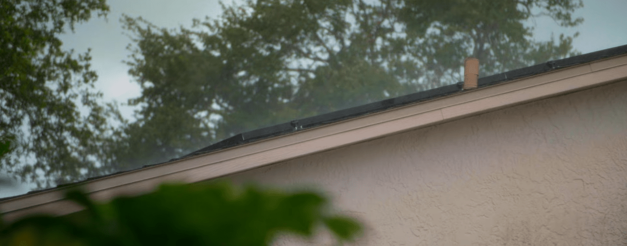 Side profile of rooftop solar panels from the ground durning a storm